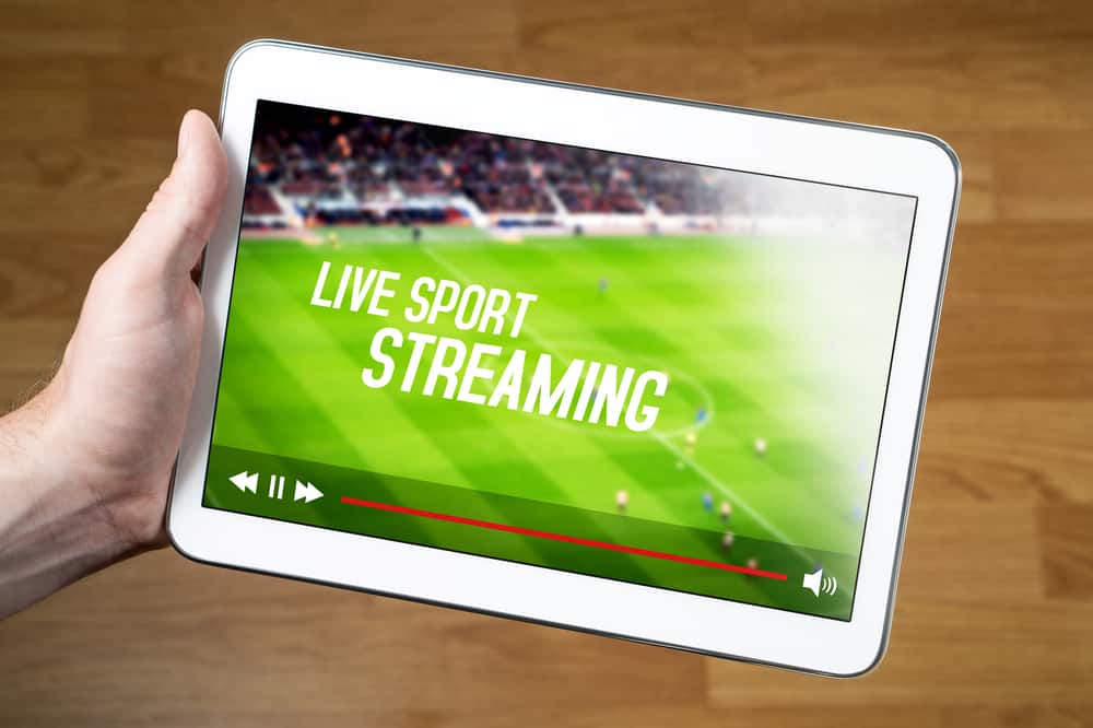 Man watching live sport stream online with mobile device