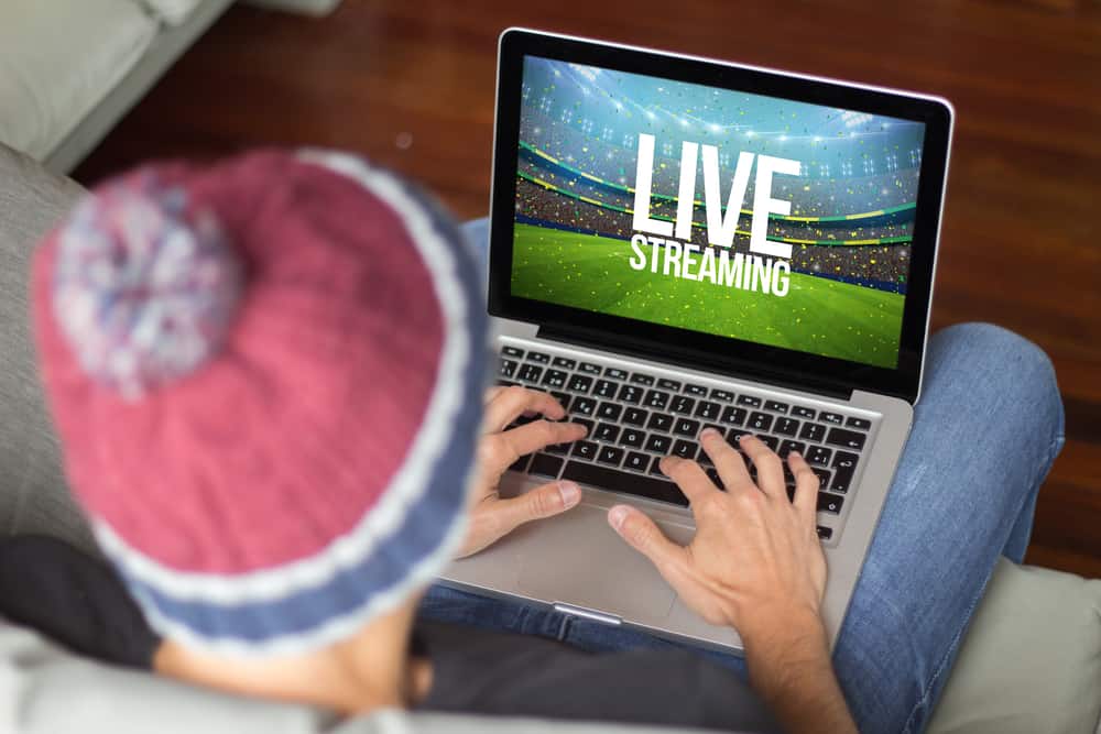 Young man watching live streaming sports event